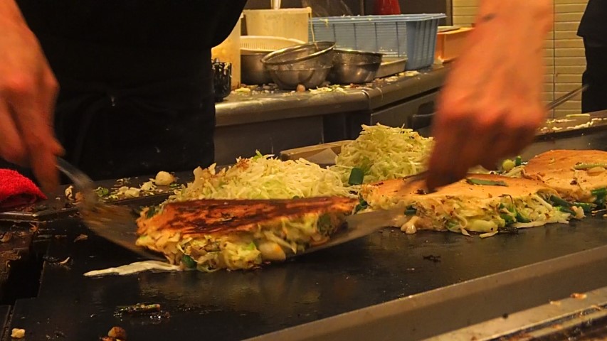 Chef cooking Okonomiyaki at Momotaro Restaurant