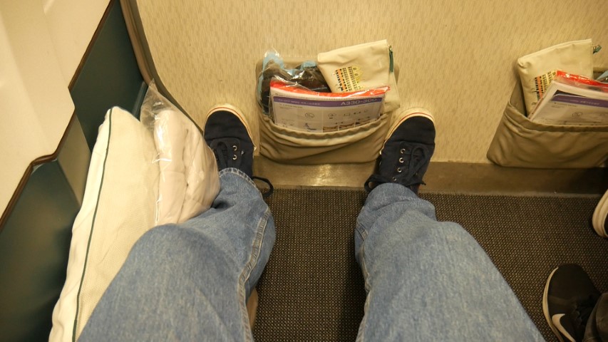Feet cramped against the wall of Premium Economy