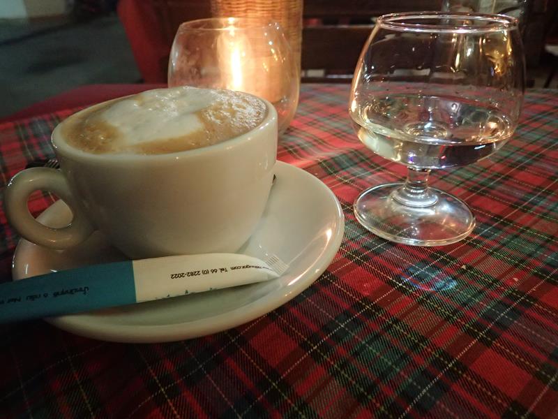 Cappuccino and glass of grappa