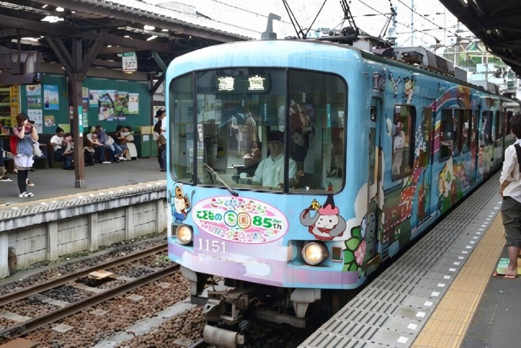 Enoden local train with cute characters livery at Hase Station Kamakura Japan – blue kids-themed train on Enoshima Electric Railway