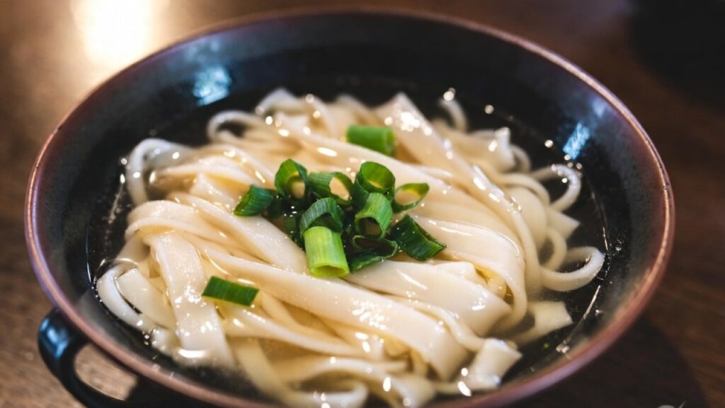 Bowl of Kishimen Nagoya traditional flat udon noodles in light dashi broth
