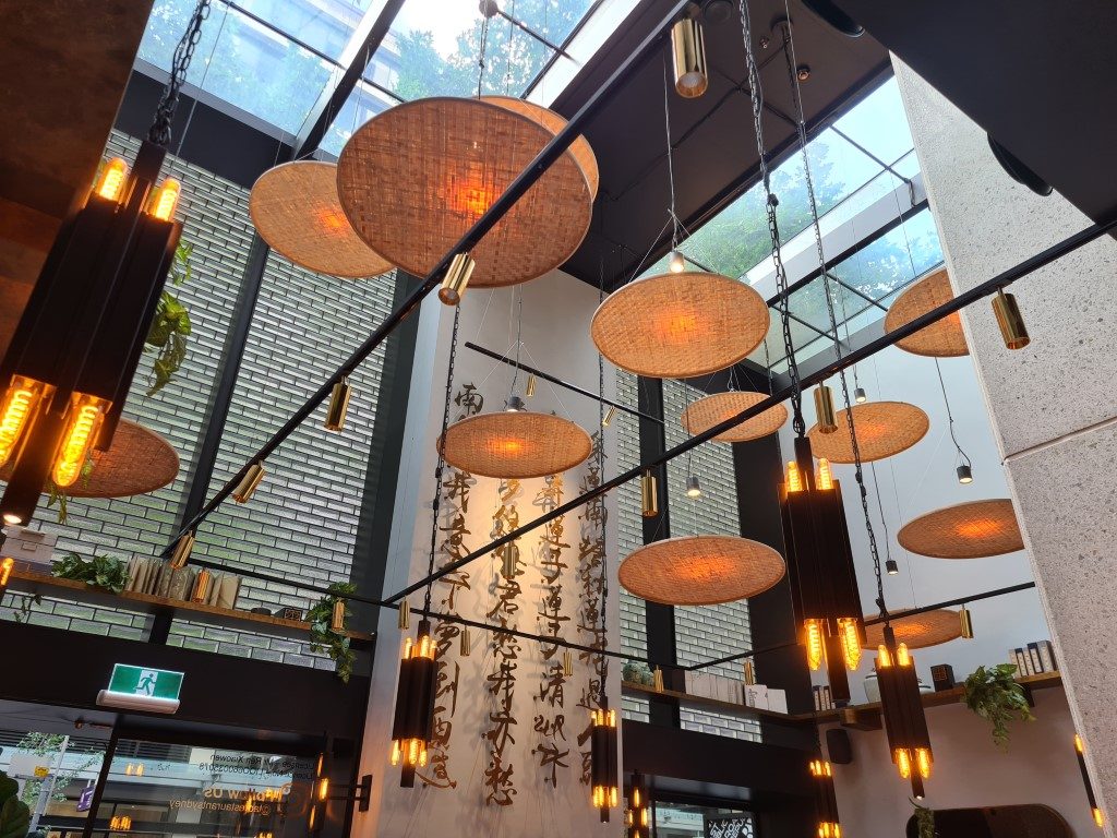 Elegant interior decor with traditional Chinese umbrellas hanging from the ceiling at Tao Restaurant in Sydney CBD, Australia