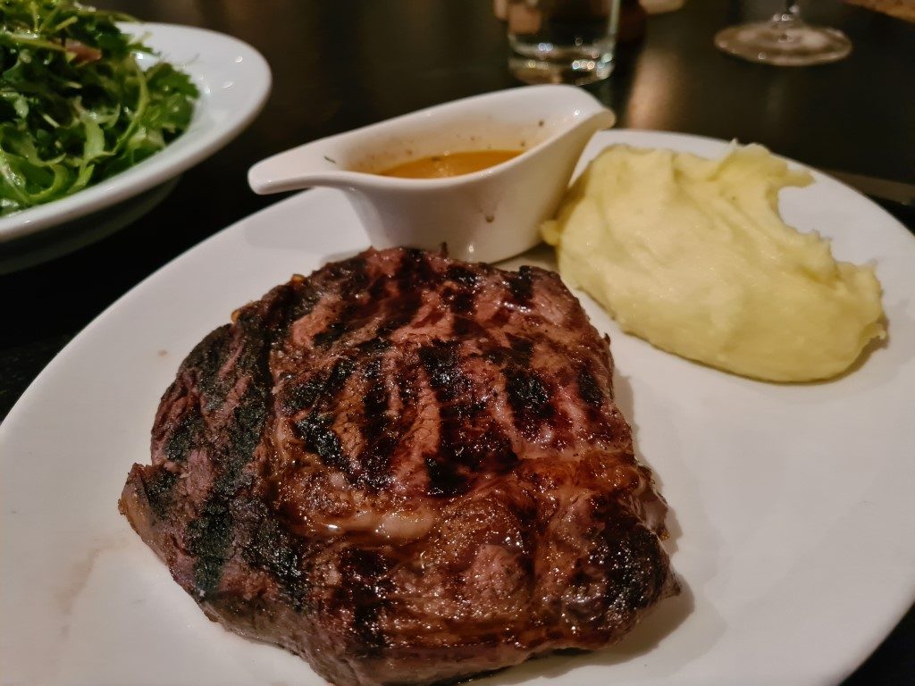 High-quality grilled steak with creamy mashed potato and pepper sauce at Kingsleys Australian Steakhouse in Sydney CBD