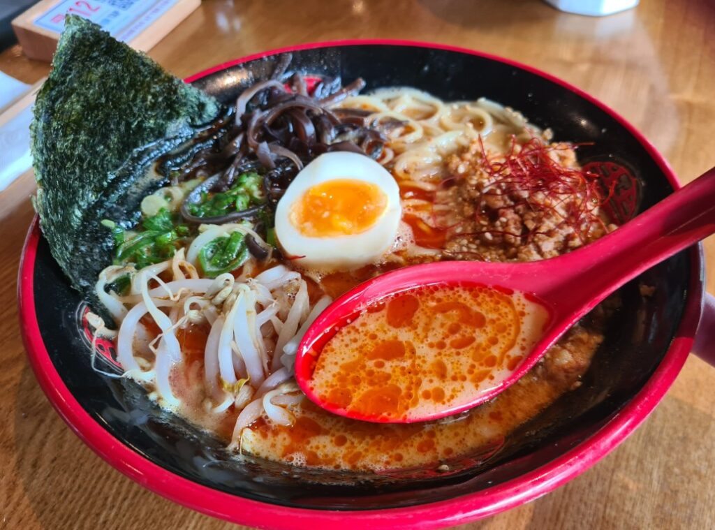 Bowl of Spicy Miso Ramen at Mikazuki Japanese Restaurant in Parramatta, featuring rich tonkotsu broth blended with spicy miso, chashu pork, soft-boiled egg, nori, spring onions, bamboo shoots, bean sprouts, and chili oil drizzle