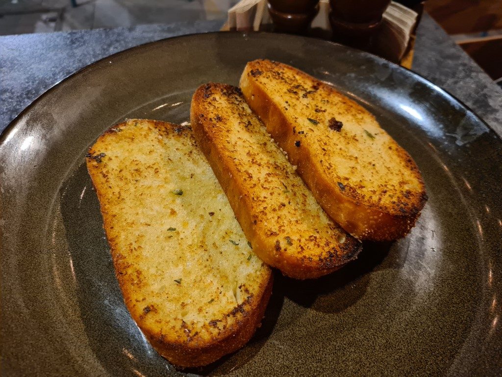 Garlic bread appetizer at Volcano's Steakhouse and Ribs Parramatta – buttery and toasted Halal side dish