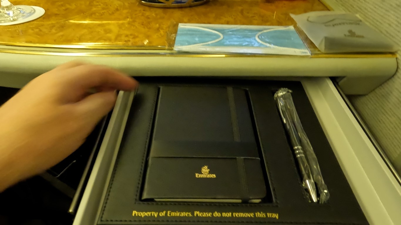Complimentary Emirates Notepad and pen in First Class