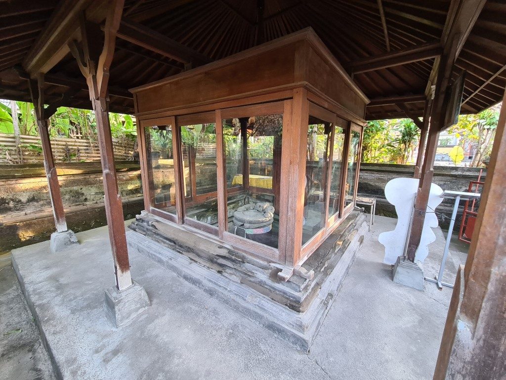 Glass enclosure protecting Belanjong Pillar in Sanur Bali 