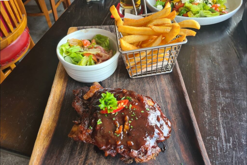 Smokey BBQ pork ribs with side salad and basket of hot chips at Firehouse Restaurant in Sanur, Bali